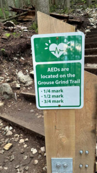 Grouse Grind trail heading signage denoting location of AEDs on the trail